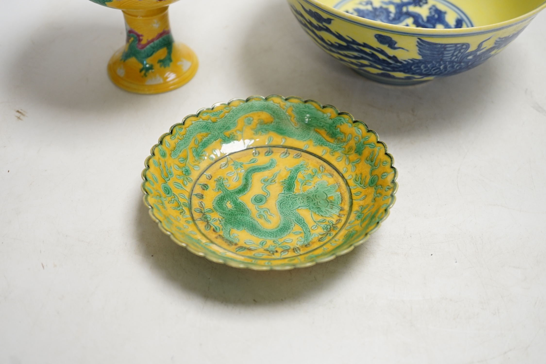 A Chinese yellow ground underglaze blue 'dragon' bowl, boxed, a yellow and green 'dragon' dish and a similar stem cup, yellow bowl 19.5cm diameter. Condition - good